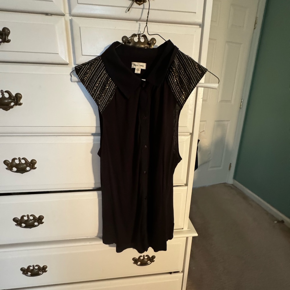 black sleeveless button up with gold hard wear on sleeves